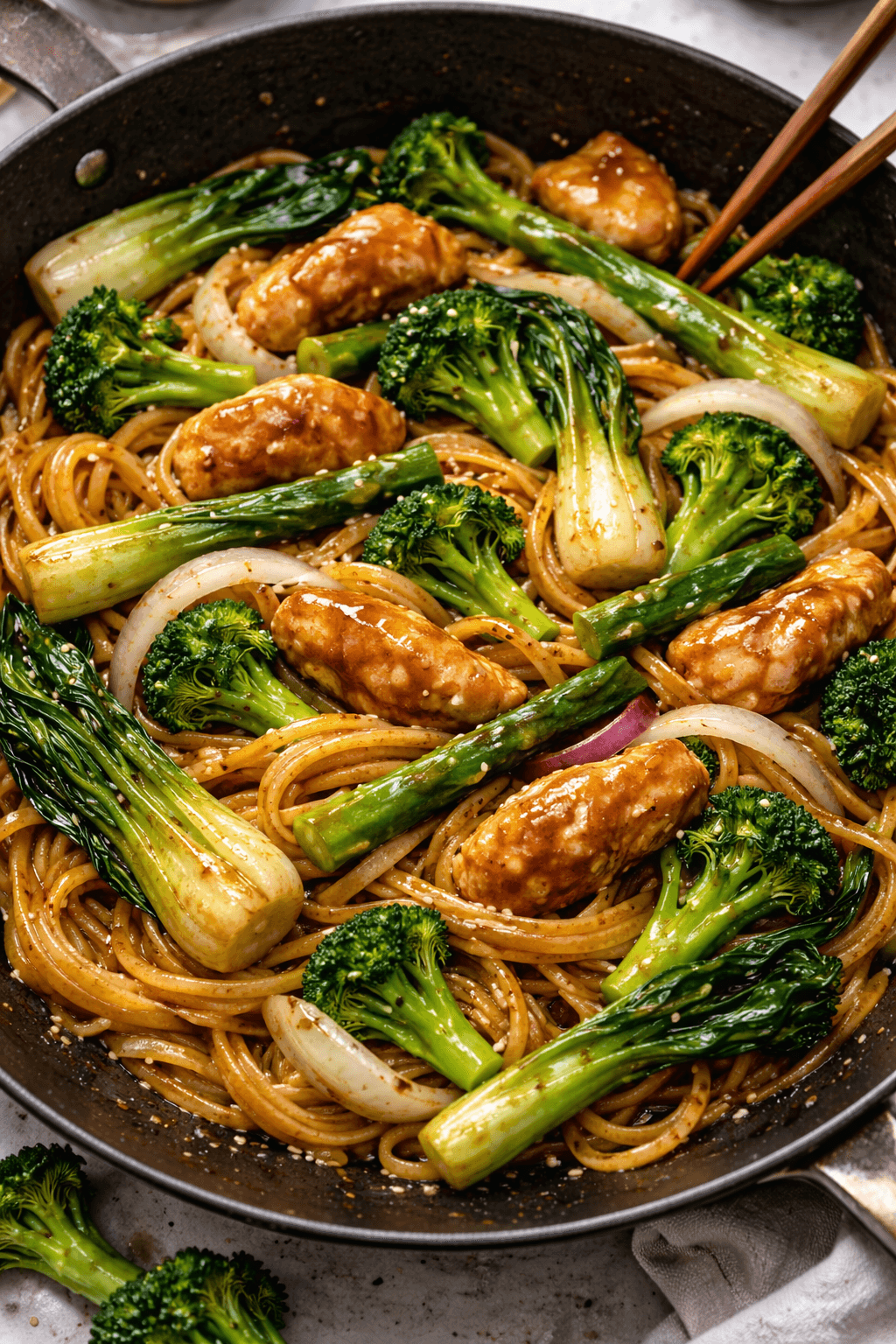 Egg noodles with onion, asparagus, bok choy, and broccoli.
